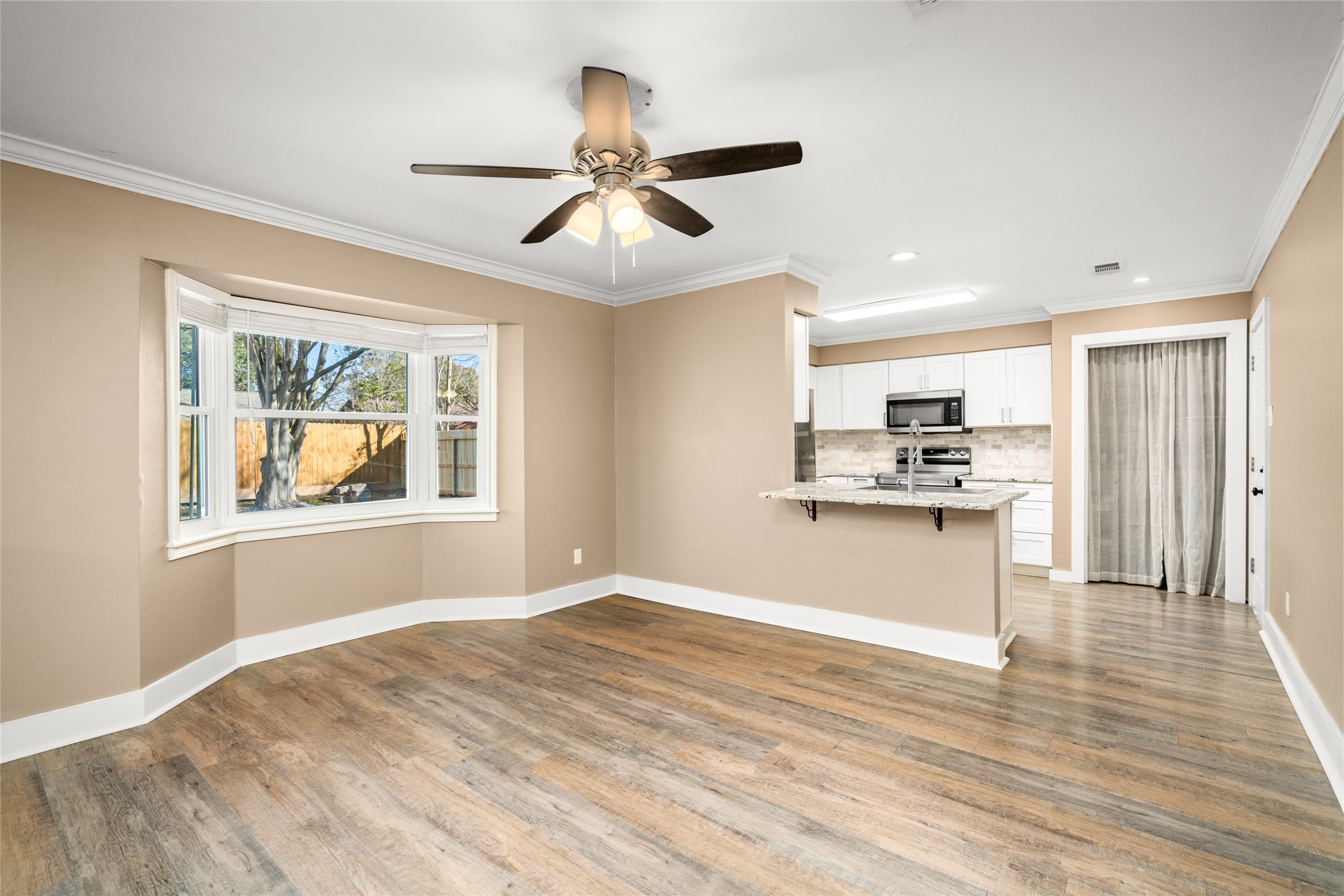 3603 Glenmeadow Drive Rosenberg, TX 77471 - Photo 11 of 27 a view of kitchen with stainless steel appliances wooden floor and window