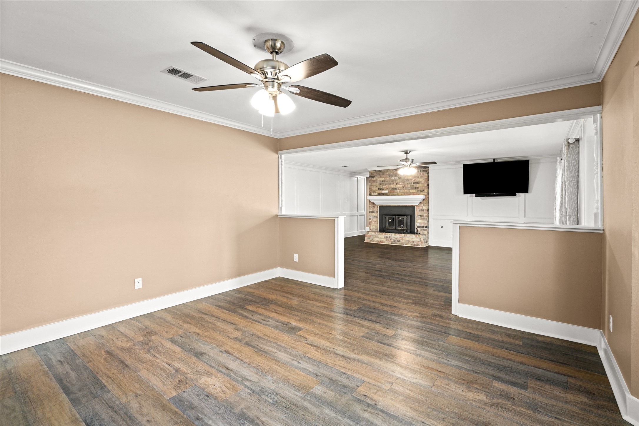3603 Glenmeadow Drive Rosenberg, TX 77471 - Photo 12 of 27 a view of a livingroom with wooden floor and a ceiling fan