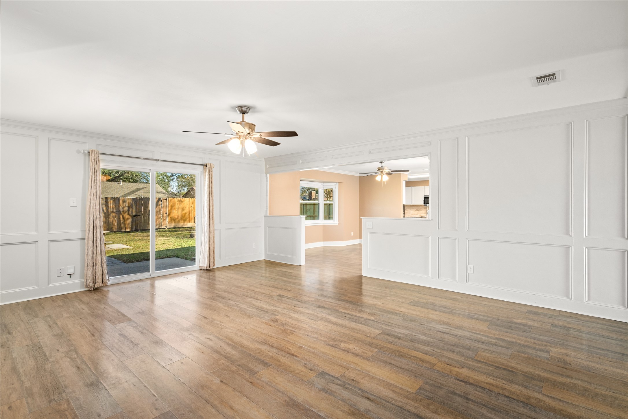 3603 Glenmeadow Drive Rosenberg, TX 77471 - Photo 15 of 27 a view of an empty room with wooden floor and a window