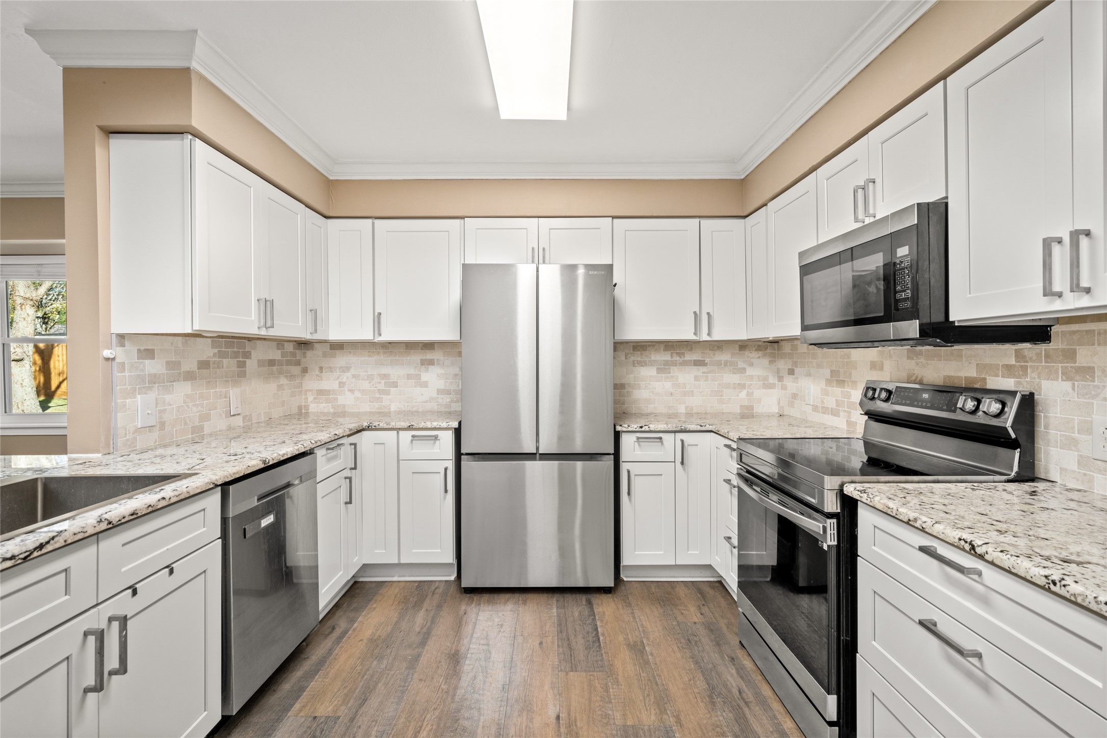 3603 Glenmeadow Drive Rosenberg, TX 77471 - Photo 2 of 27 a kitchen with granite countertop white cabinets and stainless steel appliances