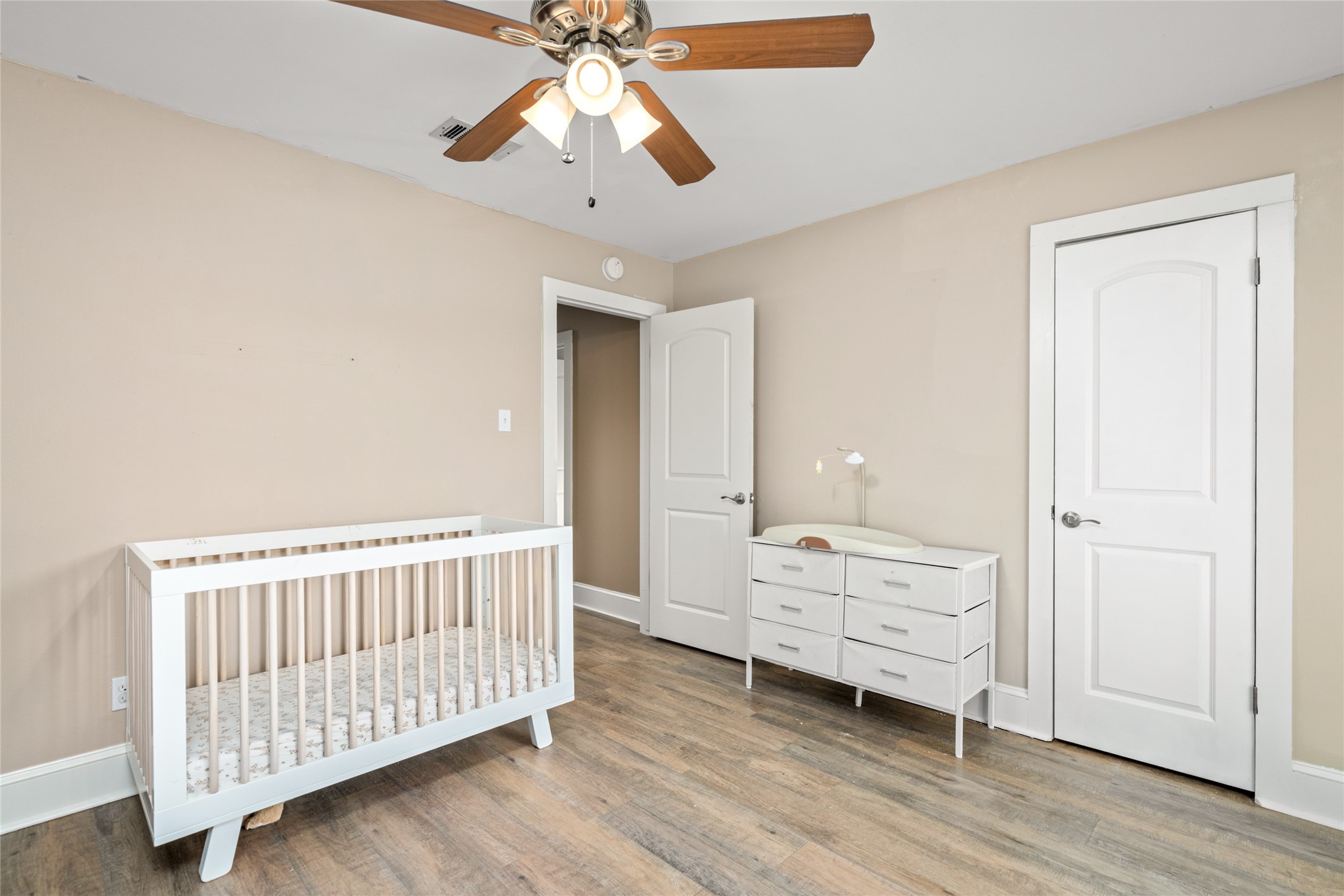 3603 Glenmeadow Drive Rosenberg, TX 77471 - Photo 21 of 27 a bedroom with a bed and wooden floor