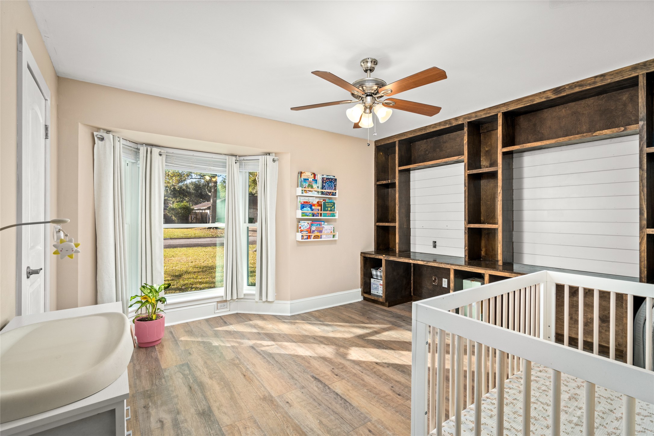 3603 Glenmeadow Drive Rosenberg, TX 77471 - Photo 22 of 27 a view of a bedroom with wooden floor and windows