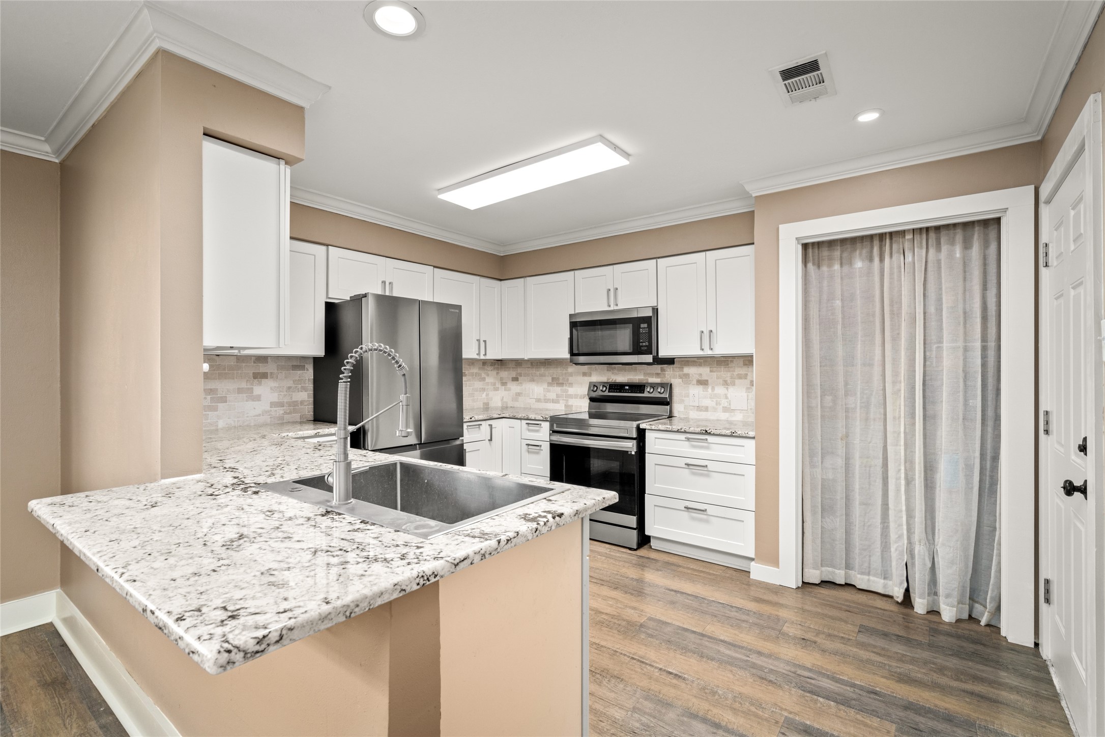 3603 Glenmeadow Drive Rosenberg, TX 77471 - Photo 3 of 27 a kitchen with a refrigerator stove and sink