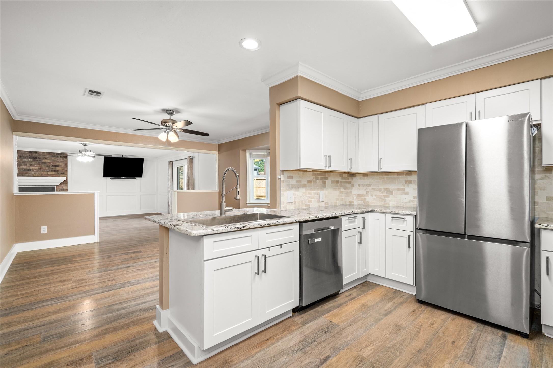 3603 Glenmeadow Drive Rosenberg, TX 77471 - Photo 4 of 27 a kitchen with stainless steel appliances granite countertop a refrigerator a stove a sink and a microwave