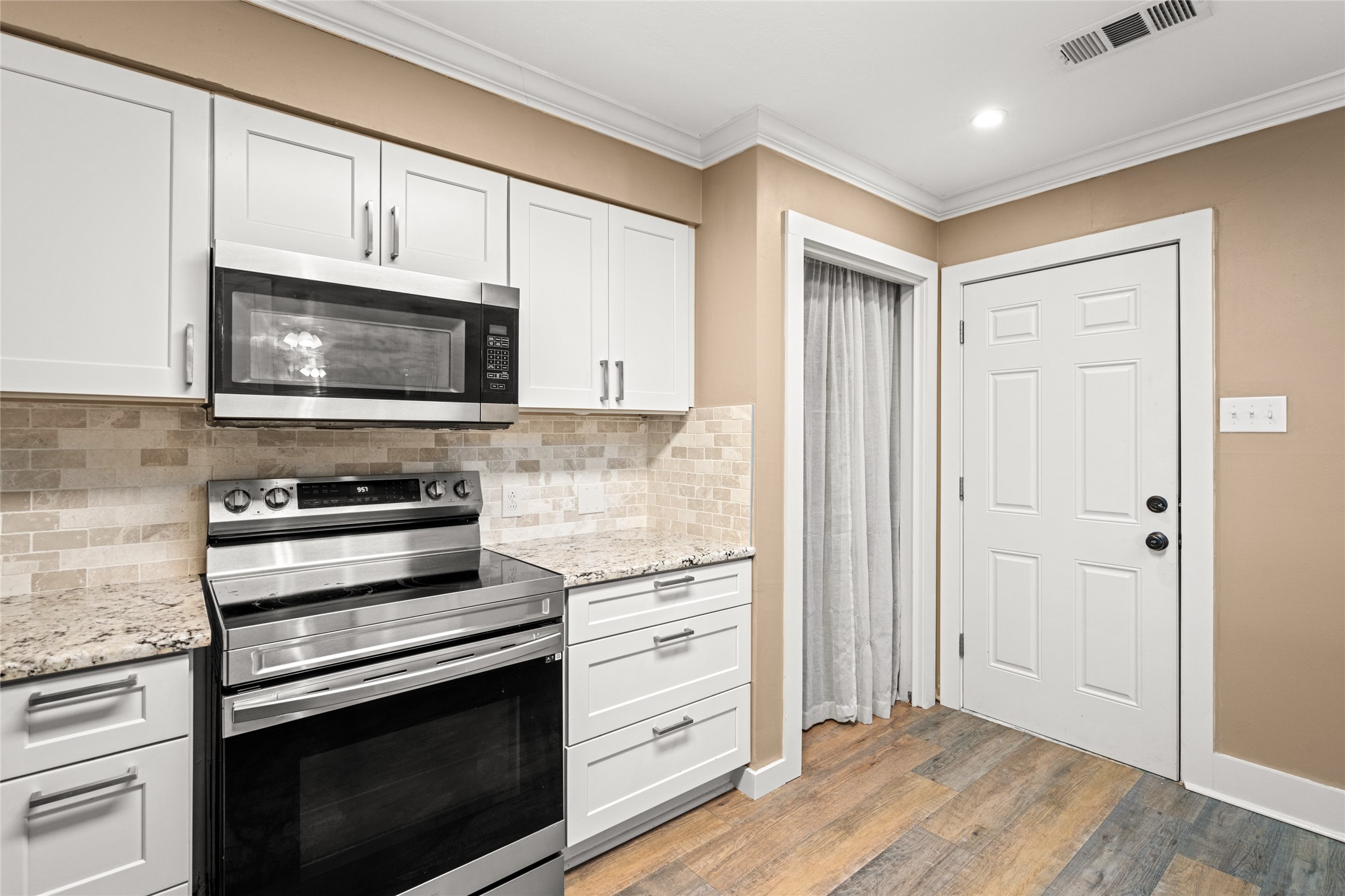 3603 Glenmeadow Drive Rosenberg, TX 77471 - Photo 5 of 27 a kitchen with stainless steel appliances granite countertop a stove microwave and cabinets