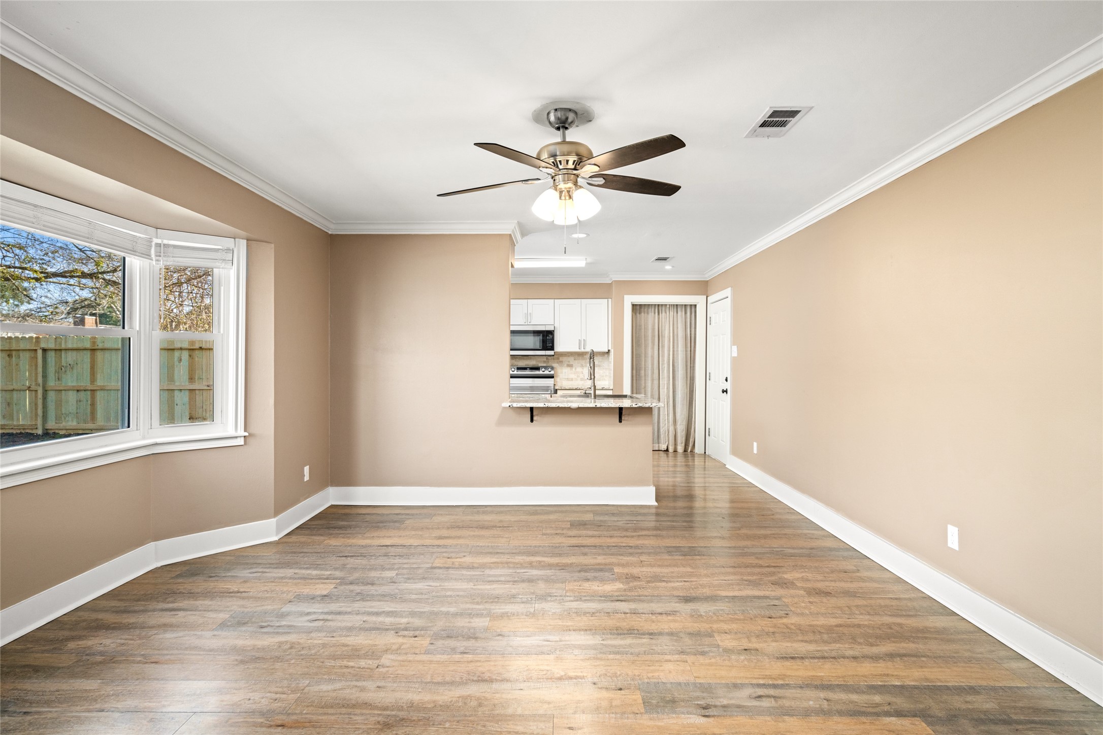 3603 Glenmeadow Drive Rosenberg, TX 77471 - Photo 10 of 27 a view of an empty room with window and wooden floor
