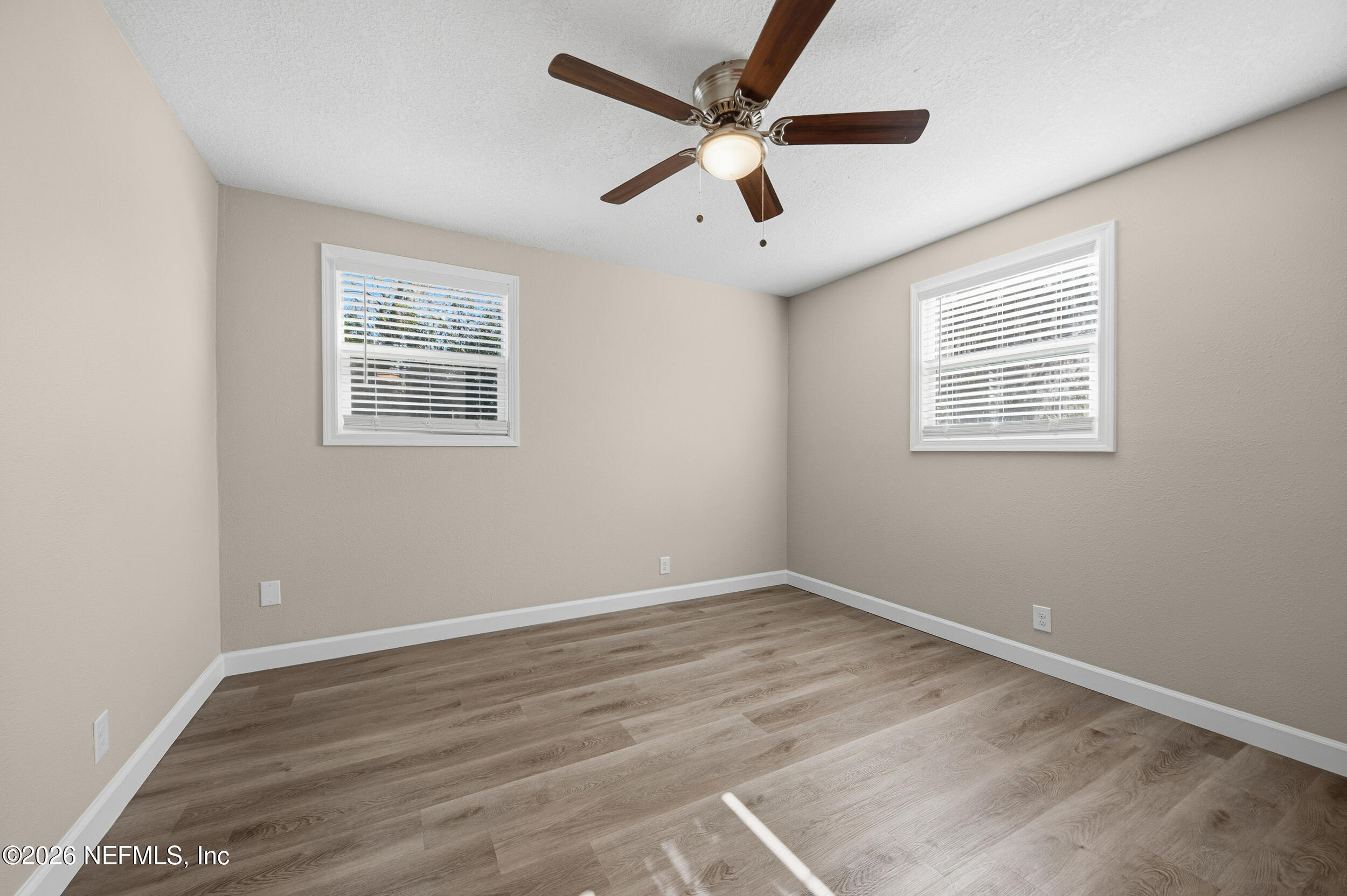 1643 Spruce Street Green Cove Springs, FL 32043 - Photo 16 of 31 an empty room with wooden floor and windows