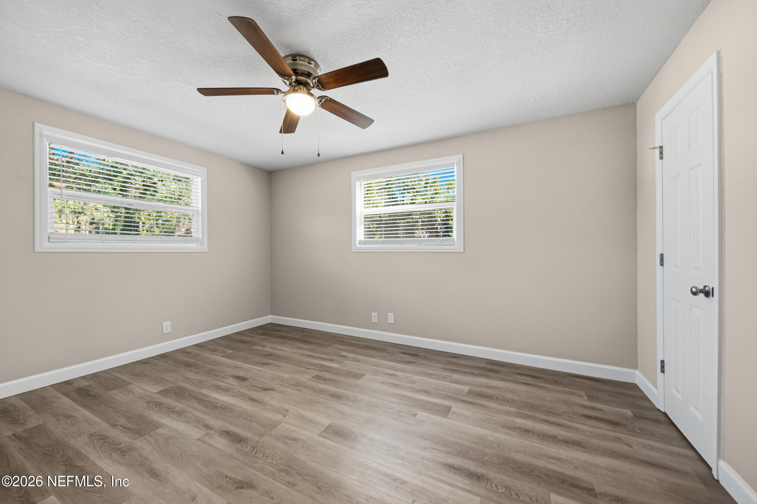 1643 Spruce Street Green Cove Springs, FL 32043 - Photo 19 of 31 a view of an empty room with wooden floor and a window