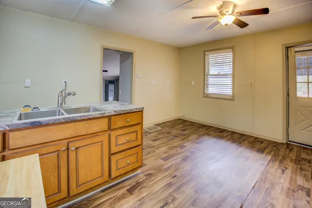 a bathroom with a sink double vanity granite and a window