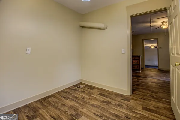 a view of a room with wooden floor
