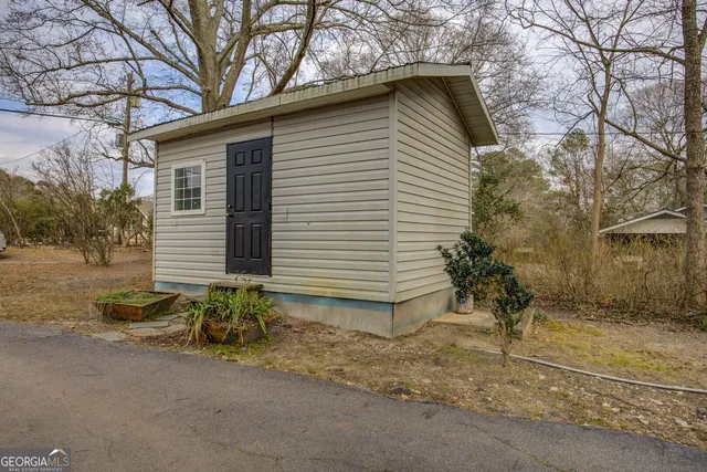 a backyard of a house with table and chairs