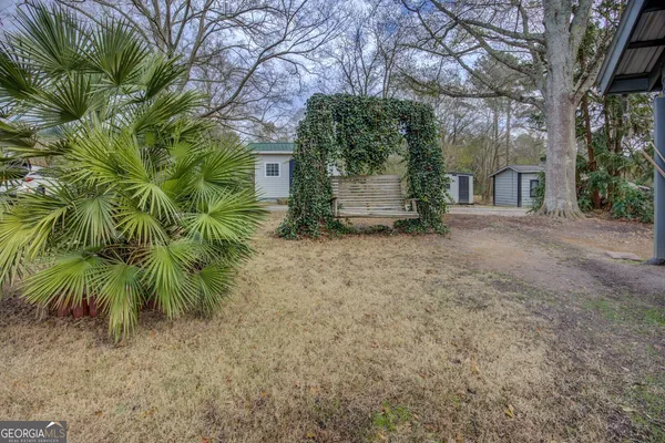 a view of a house with a tree in the background