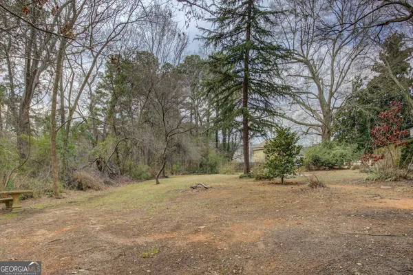 a view of outdoor space with large trees