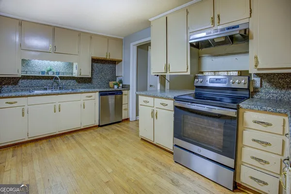 a kitchen with stainless steel appliances granite countertop a stove and a sink