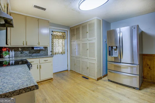 a kitchen with granite countertop stainless steel appliances and counter space