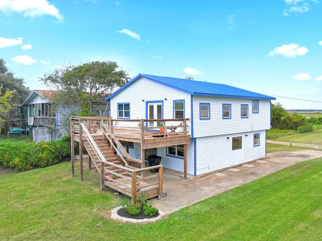 a view of a house with a yard and sitting area