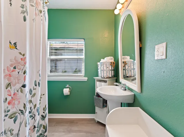 a bathroom with a toilet sink and mirror