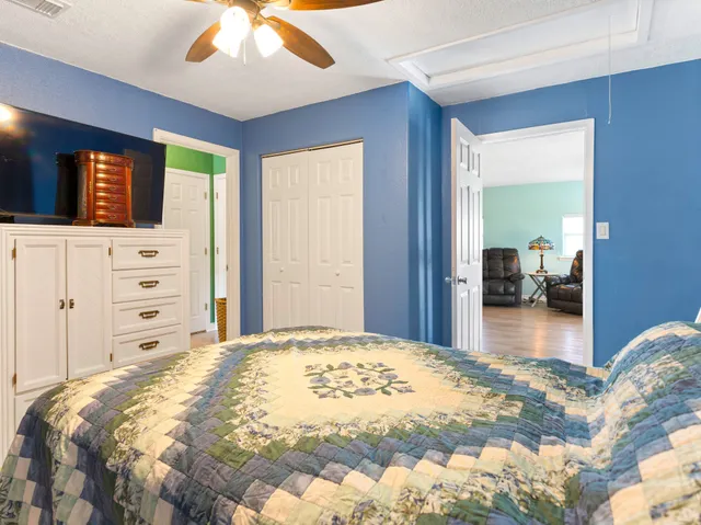 a bedroom with a large bed and a dresser