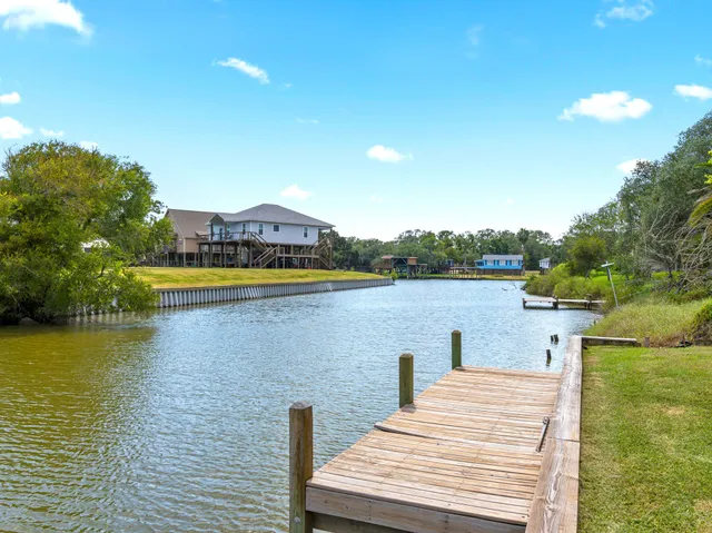 a view of a lake with houses in the back