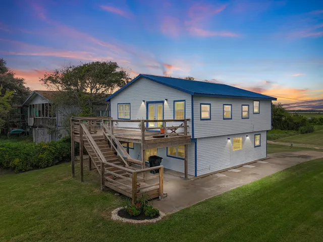 a view of a house with backyard porch and sitting area