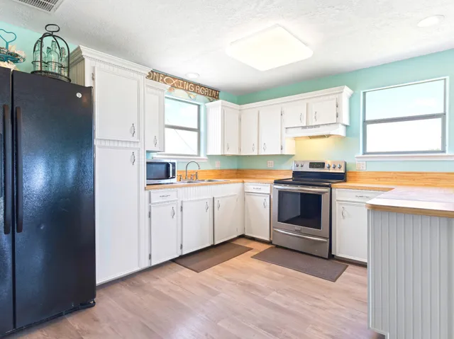 a kitchen with a white stove top oven and sink