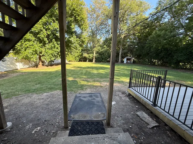 a view of a yard with large trees