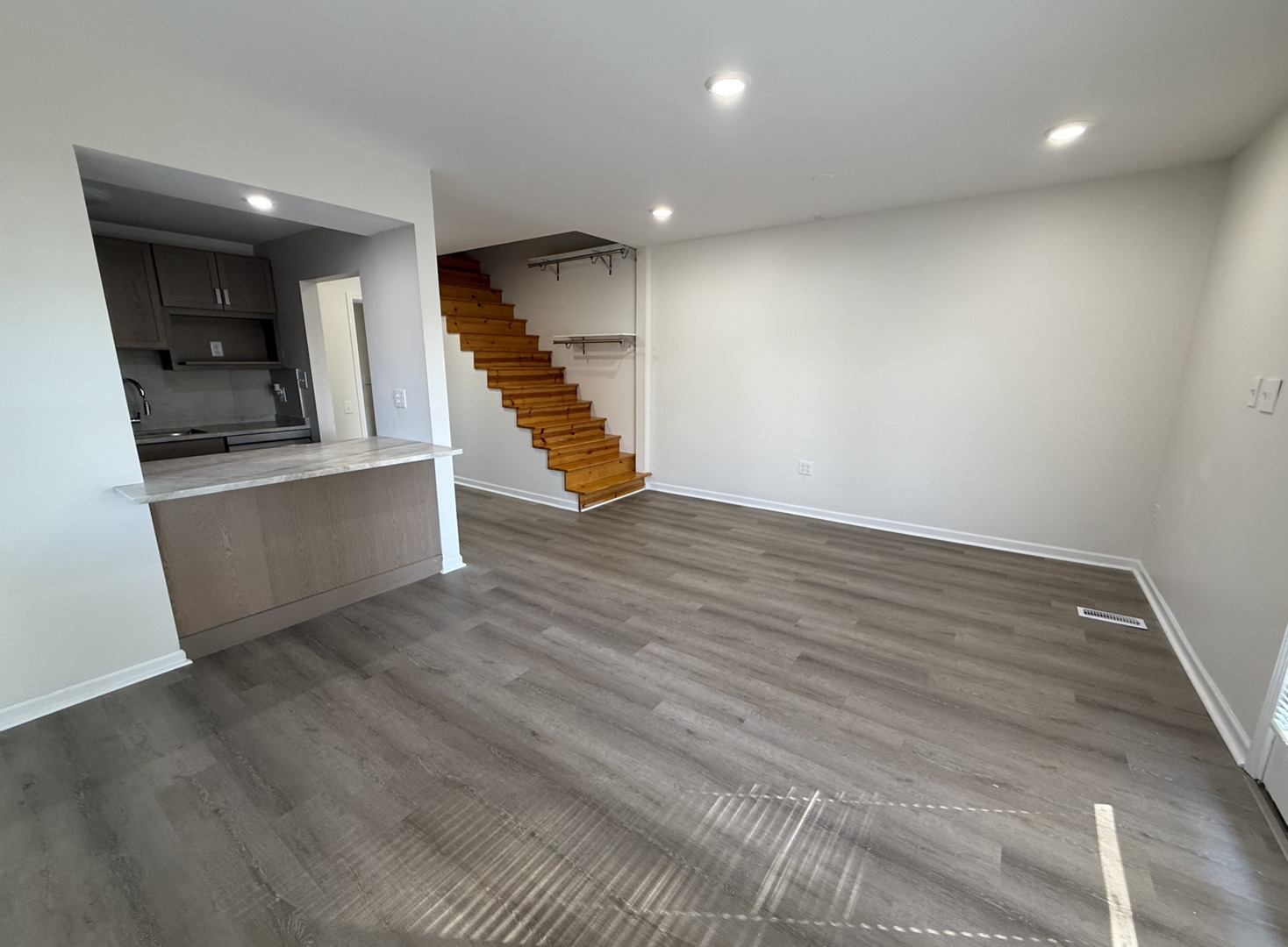 59 9s115 Route, Unit 1 Naperville, IL 60564 - Photo 2 of 12 wooden floor in an empty room with a kitchen