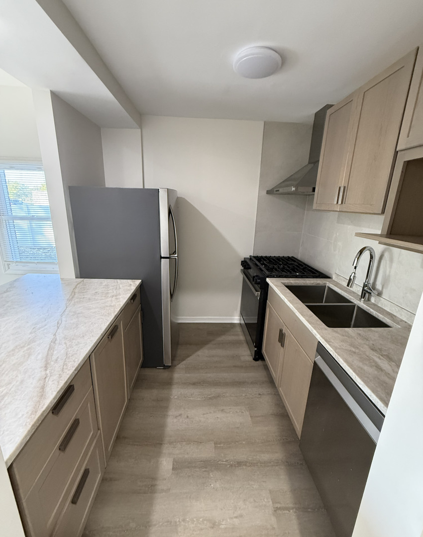 59 9s115 Route, Unit 1 Naperville, IL 60564 - Photo 4 of 12 a kitchen with a stove and a refrigerator