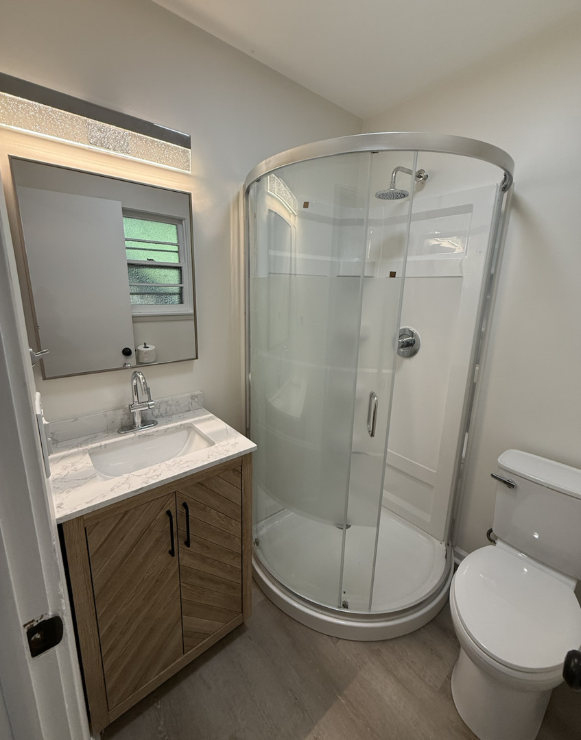 59 9s115 Route, Unit 1 Naperville, IL 60564 - Photo 8 of 12 a bathroom with a granite countertop sink toilet and shower
