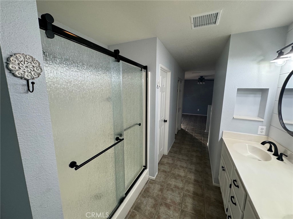 31781 Canyon Estates Drive Lake Elsinore, CA 92532 - Photo 16 of 25 a bathroom with a tub sink and mirror