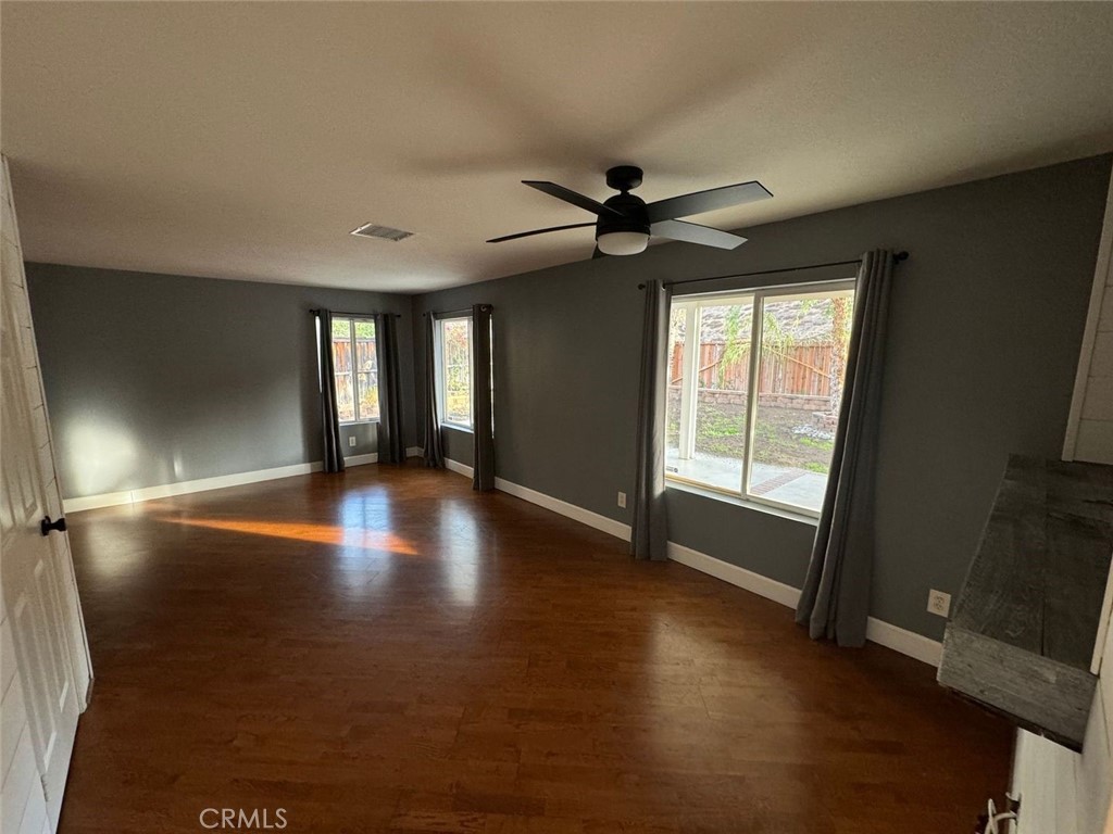 31781 Canyon Estates Drive Lake Elsinore, CA 92532 - Photo 3 of 25 a view of empty room with wooden floor and fan
