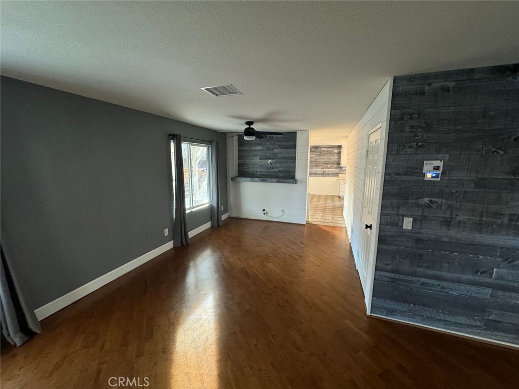 31781 Canyon Estates Drive Lake Elsinore, CA 92532 - Photo 4 of 25 an empty room with wooden floor and windows