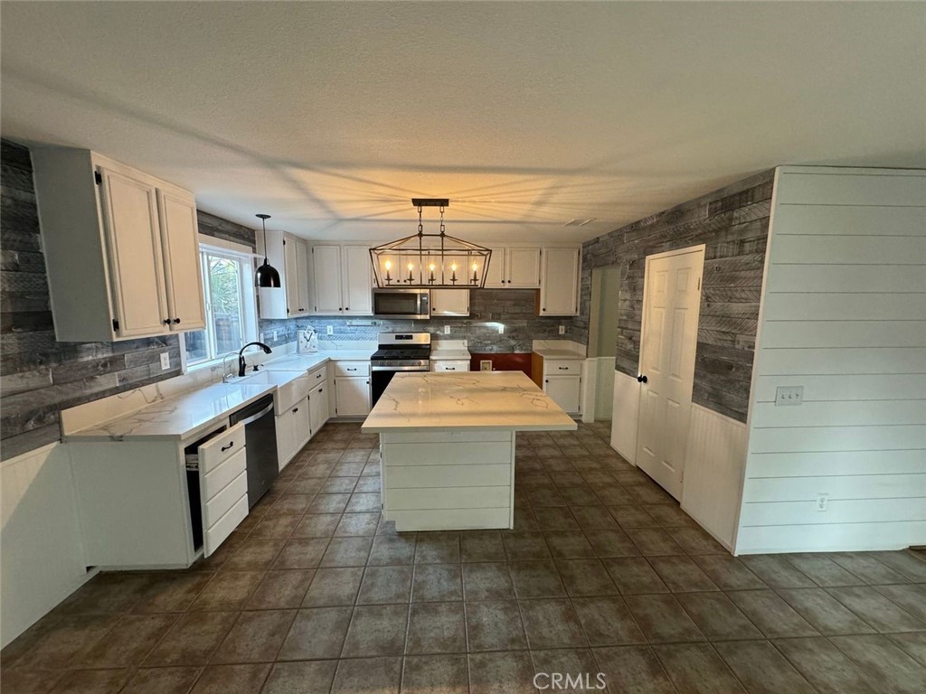 31781 Canyon Estates Drive Lake Elsinore, CA 92532 - Photo 5 of 25 a large white kitchen with a large window