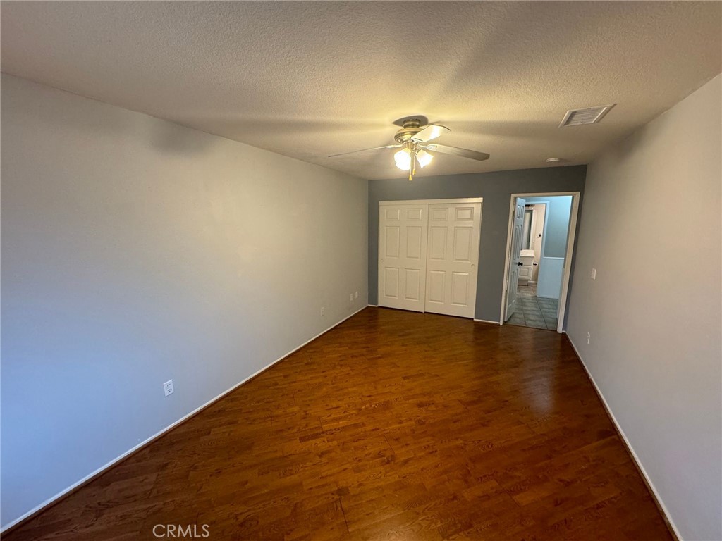31781 Canyon Estates Drive Lake Elsinore, CA 92532 - Photo 7 of 25 an empty room with a ceiling fan and carpet