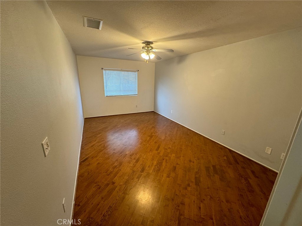 31781 Canyon Estates Drive Lake Elsinore, CA 92532 - Photo 8 of 25 an empty room with a empty space and a ceiling fan
