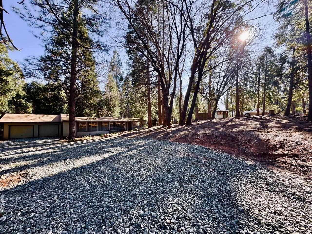 5790 Reservoir Road Georgetown, CA 95634 - Photo 2 of 7 a view of a backyard with large trees