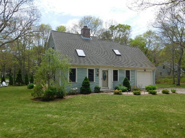 62 Quisset Road Centerville, MA 02632 - Photo 1 of 25 a front view of house with yard outdoor seating and green space