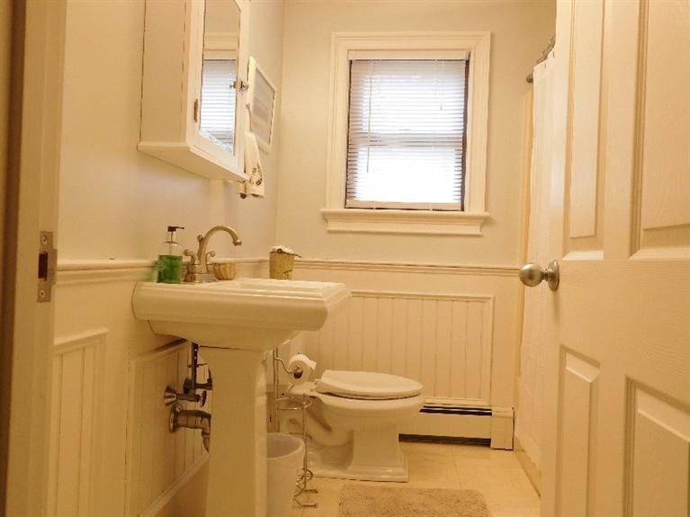 62 Quisset Road Centerville, MA 02632 - Photo 11 of 25 a bathroom with a sink a toilet and a mirror