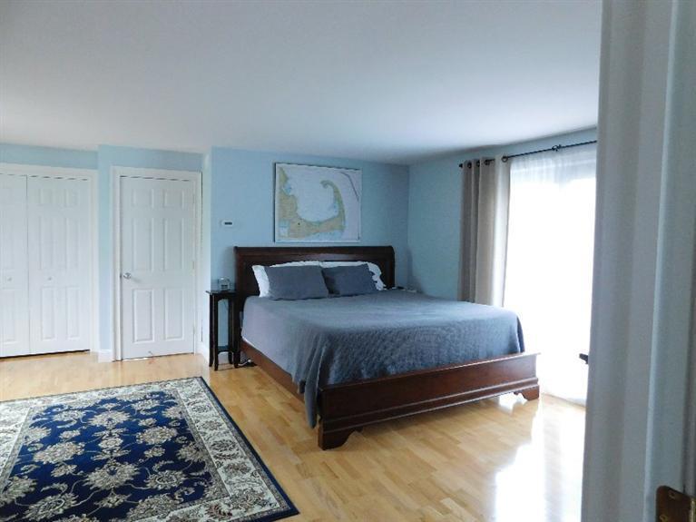 62 Quisset Road Centerville, MA 02632 - Photo 16 of 25 a bedroom with a bed and wooden floor