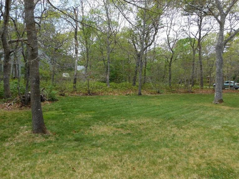 62 Quisset Road Centerville, MA 02632 - Photo 21 of 25 a view of a grassy field with trees in the background