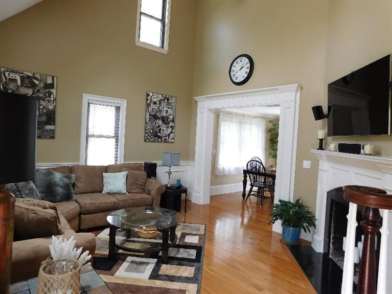 62 Quisset Road Centerville, MA 02632 - Photo 3 of 25 a living room with furniture a fireplace and a flat screen tv