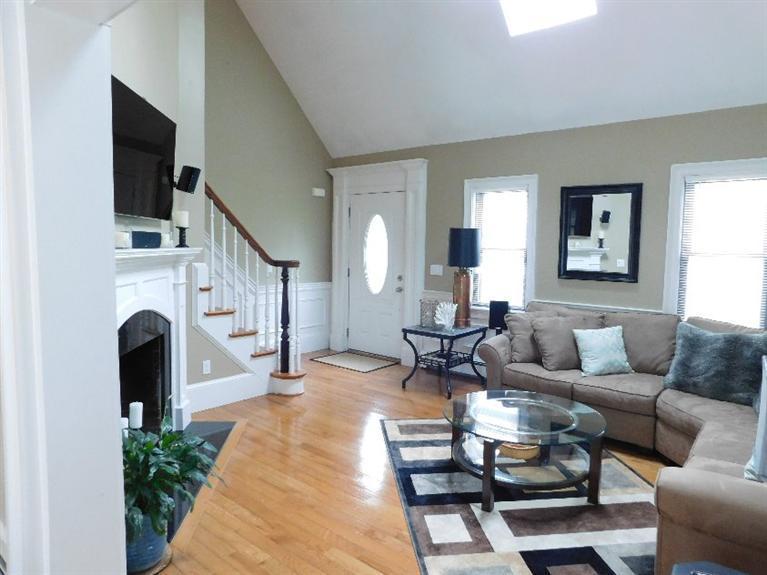 62 Quisset Road Centerville, MA 02632 - Photo 5 of 25 a living room with furniture a fireplace and a flat screen tv