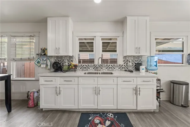 a kitchen with stainless steel appliances granite countertop a sink and cabinets