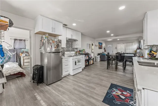 a kitchen with stainless steel appliances granite countertop a refrigerator sink and cabinets