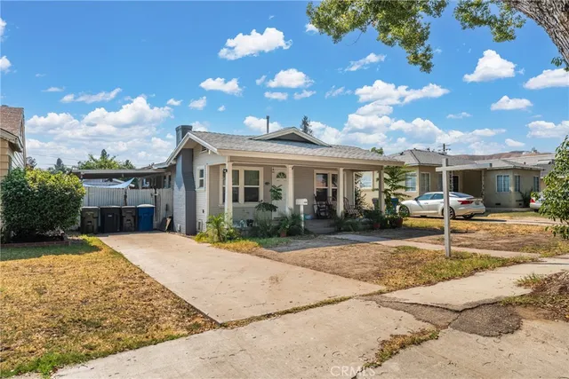 a backyard of a house with table and chairs
