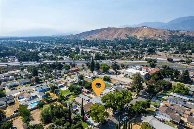 an aerial view of residential house with an outdoor space and seating