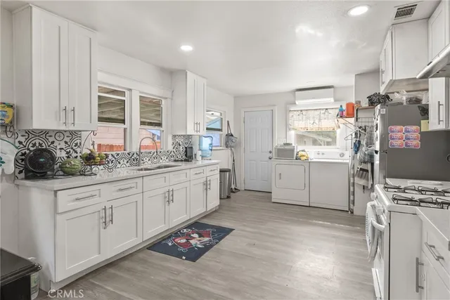 a kitchen with stainless steel appliances kitchen island granite countertop a sink stove and cabinets