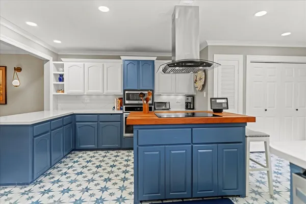 a kitchen with kitchen island granite countertop a stove and a sink