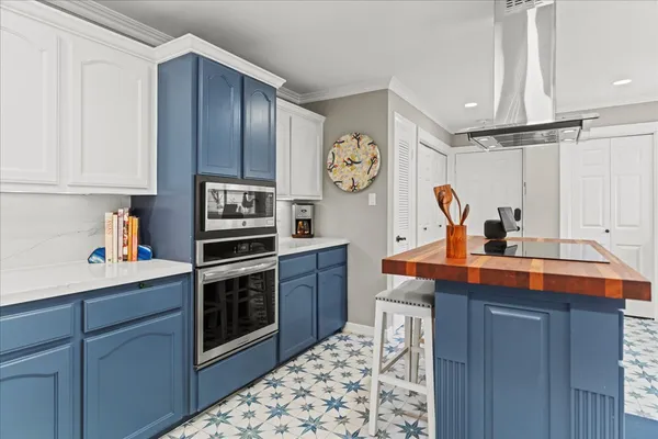 a kitchen with stainless steel appliances a sink cabinets and wooden floor