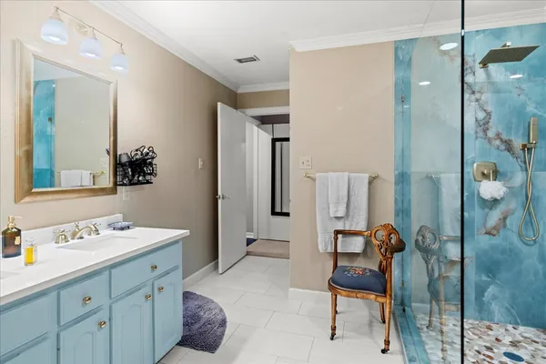 a en suite bathroom with a double vanity sink mirror and shower